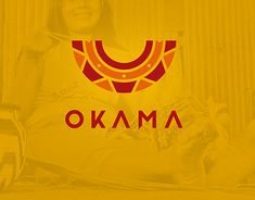 a woman sitting in front of a yellow background with the word okama on it