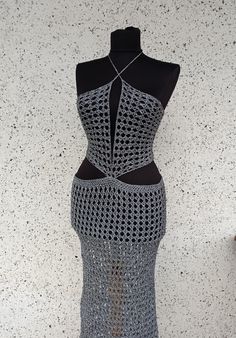 a crocheted dress is displayed on a mannequin