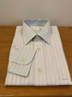 "Vintage unworn pale blue shirt with pink and yellow striped pattern in cotton polyester mix from the Europa range by Van Heusen.  Details: straight collar, long sleeves, single cuff, regular fit.  Made in England  60% Cotton 40% Polyester  Size 15\" 38cm S/M" Mens Dress Shirts, Mens Dress, Van Heusen, Yellow Stripes, Tee Dress, Mens Shirt Dress, Blue Shirt, Dress Shirts, Pale Blue