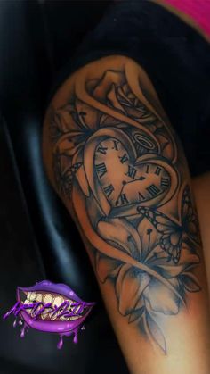 a woman's arm with a clock and rose tattoo on it, next to a purple object