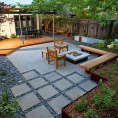 an outdoor patio with wooden furniture and stone steps leading to the back yard, surrounded by greenery