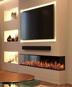 a living room with a large television mounted on the wall next to a fire place