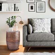 a living room filled with furniture and pictures on the wall