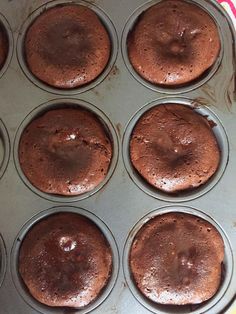 chocolate cupcakes in a muffin tin ready to be baked into the oven