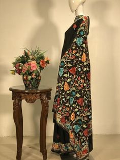 A Marvellous Embroidered Kashmiri Saree which you can wear at any party or a wedding.- - - - - - - - - - - - - - - - - - - - Product Details- Condition: Brand New (made to order)- Style: Saree Dress- Embroidery: All-over Kashmiri Aari Embroidery.- Base Colour: Black- Embroidery Colour: Multi-colour- Care Instructions: Dry Clean OnlyF A B R I CSaree: Viscose GeorgetteBlouse: Indian CrepeF I N I S H- UnstitchedYou can get it stitched locally.- StitchedWant your blouse ready to wear, let us know th Floor-length Multicolor Traditional Wear With Floral Embroidery, Multicolor Floor-length Traditional Wear With Floral Embroidery, Embroidered Jamawar Pashmina Shawl For Wedding, Floor-length Embroidered Dupatta For Transitional Season, Embroidered Floor-length Dupatta, Transitional Embroidered Floor-length Dupatta, Transitional Floor-length Embroidered Dupatta, Wedding Jamawar Pashmina Shawl With Intricate Embroidery, Wedding Pashmina Shawl With Intricate Embroidery