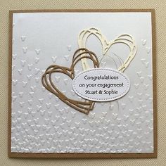 congratulations on your engagement card with heart cutouts and paper hearts attached to the back