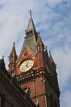 a large clock tower with a sky background