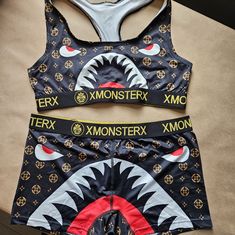 This Xmonsterx Grappling Women's Set In Size Large Is Perfect For Mma And Sports Enthusiasts. The Set Includes A Black Bra And Shorts Made From A Blend Of Polyester And Spandex Fabric That Provides Comfort And Flexibility During Intense Workouts. The Fangs Pattern And Sports Theme Add A Touch Of Style To The Set, Making It Perfect For Activewear. The Two-Piece Set Is Suitable For Women Of All Sizes And Is Not Vintage. The Brand Is Xmonsterx And The Set Is Categorized Under Clothing, Shoes & Acce Black Sporty Sets With Graphic Print, Sporty Black Sets With Graphic Print, Black Stretch Sets With Letter Print, Fitted Black Sets With Letter Print, Black Graphic Print Sets For Streetwear, Trendy Black Sets With Graphic Print, Trendy Black Graphic Print Sets, Trendy Black Graphic Print Set, Grappling