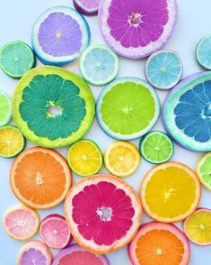 citrus fruit cut in half and arranged on white surface with oranges, lemons, and grapefruit