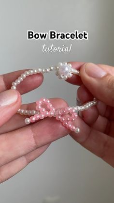 a person holding a pink bow bracelet with pearls on it and the words bow bracelet