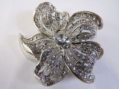 Beautiful Flower Brooch with a silver or gold tone and sparkling diamante stones. Perfect accessories for weddings, parties, or any occasion diameter - 5cm  Price per 1 pcs Silver Rhinestone Brooches As Gifts, Silver Brooch Lapel Pin For Wedding, Silver Wedding Lapel Pin, Silver Rhinestone Brooches For Gifts, Silver Flower Pins For Wedding, Luxury Flower-shaped Brooches For Anniversary, Silver Flower Wedding Pins, Silver Flower Brooch Pins, Elegant Diamond Flower Brooches