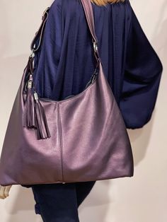 Hobo Bag in Pearlised Antique Purple Leather  - Premium leather with chambray cotton lining (see photo lining 2) *  I have only 1 in stock for the Pearlised Antique Purple Leather Bag  *  1 inside zipper pockets. 2 leather edged slip pockets (both fit large cell phone) *  One Large compartment. *  High quality, double sided, strong adjustable shoulder strap. *  Strong ykk zipper closure.  *  Silver hardware.  *  Comes with double removable leather tassel, with designer hardware.      *  metal feet on bottom of Bag Size: LARGE: W 42cm (17") (at the bottom, laying the bag flat), Centre H 28cm (11"), Side H 39cm (15.5") Depth at bottom 9.5cm (3.8 inch) Strap: drop from strap to bag, up to 41cm (16 inch) 1.2" wide. Tassels: 14cm long This bag is ready NOW.   This bag can be made in other metal Purple Tote Hobo Bag For Everyday Use, Purple Hobo Tote Bag For Everyday Use, Purple Satchel Hobo Bag For Everyday, Purple Soft Leather Shoulder Bag For Everyday, Everyday Purple Shoulder Bag With Zipper, Purple Double Handle Hobo Bag For Everyday, Purple Travel Hobo Bag, Purple Satchel Hobo Bag For Daily Use, Purple Hobo Bag Satchel For Daily Use