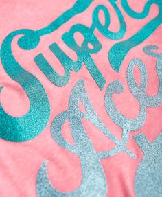 a pink shirt with the words super dry printed on it