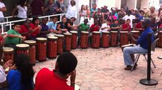 a group of people playing drums in front of a crowd