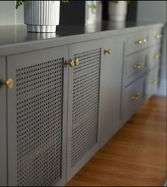 a potted plant sitting on top of a gray cabinet