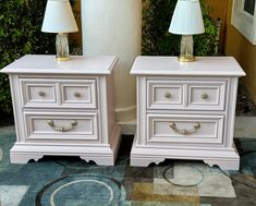 two white nightstands sitting next to each other on top of a carpeted floor