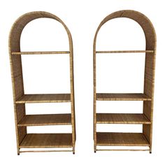 a pair of shelves made out of wicker with arched top and bottom shelfs