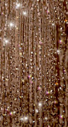 rain drops falling down on the ground and in front of a brown background with white dots