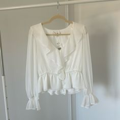 Adorable Long Sleeve, Sheer, Tie Front, Blouse With Ruffle Detail. Perfect Work Wear Option Or A Date Night Out! New With Tags! Does Run Small. White V-neck Blouse With Ruffles, Feminine White V-neck Blouse, Flowy Elegant Blouse For Day Out, Elegant Flowy Blouse For Day Out, Chic White V-neck Blouse, White Feminine Blouse For Daywear, White Flowy Blouse For Daywear, White Feminine Blouse For Brunch, White Flowy Top For Daywear