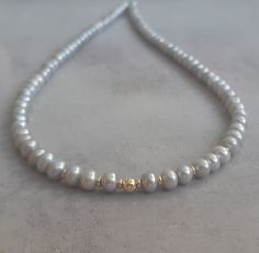 14k solid yellow gold and light gray fresh water pearl necklace/chocker. Modern up to date with a chic statement ! Easy to wear day or night this necklace is timeless ! Good quality AAA gray button pearls with 14k solid gold rondelle beads and a 14k solid gold spring ring clasp. Measures: Pearls - 5mm approx Necklace length - please select in the drop down menu. 100% solid gold hallmarked on clasp. Can be worn alone or layered with other necklaces-as a chocker or longer.. Gray Pearl Necklace For Gift, Gray Pearl Necklace For Gifts, Gray Single Strand Pearl Necklace As Gift, Gray Pearl Necklace, Fresh Water Pearl Necklace, Grey Pearl Necklace, Pearl Necklace Gold, Water Pearl Necklace, Natural Pearl Necklace