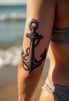 a woman's arm with an anchor tattoo on it