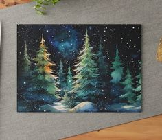 a painting of trees in the snow on a table