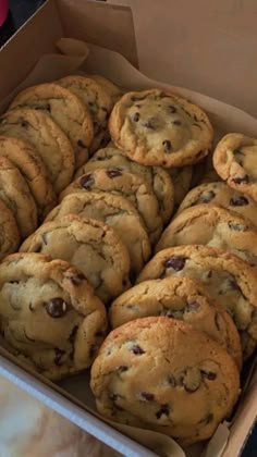 a box filled with chocolate chip cookies on top of a table