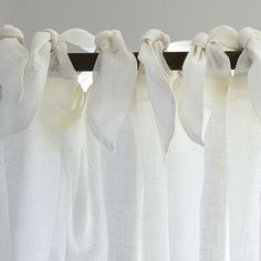 white curtains with bows hanging from them