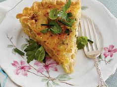 a piece of quiche on a plate with a fork