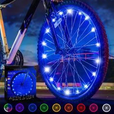 a bicycle wheel with lights on it is shown in front of an advertisement for the company