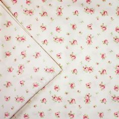 two sheets with pink flowers on them are laying next to each other in the same pattern