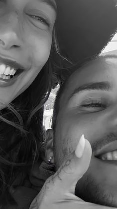 a man and woman are smiling together in the back seat of a car with their eyes closed