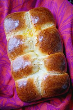 a loaf of bread sitting on top of a purple blanket