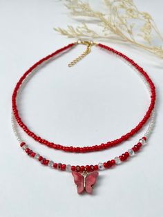 This dainty, layered necklace is beautifully crafted, and brings a whimsical touch to any outfit. Beautiful  re-beaded necklace made with seed beads and a red butterfly pendant. Each necklace is handmade and carefully crafted to ensure durability for everyday wear.  This two-layer necklace is attached with a crimp bead for a nice, neat look. The layers of the necklace differ by one inch in length, with an adjustable 2 inch extender chain (the size listed is for the SHORTER layer). I offer nine different lengths. If you would like a different length, please feel free to leave a message. My business thrives on Customer Satisfaction Please do not hesitate to reach me if there is something wrong with your purchase. I will try my best to make it right for you. Thank you for shopping JGBestBeade Trendy Adjustable Layered Necklace Gift, Beaded Chain Layered Choker Necklace As Gift, Layered Beaded Choker Necklace As A Gift, Handmade Layered Necklace With Round Beads For Gifts, Gift Beaded Chain Layered Choker Necklace, Trendy Beaded Clavicle Chain Necklace As Gift, Adjustable Beaded Chain Layered Necklace Gift, Gift Layered Choker Necklace With Beaded Chain, Adjustable Beaded Chain Layered Necklace For Gift