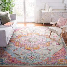 a living room with a couch, chair and rug