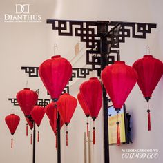 red lanterns are hanging from the ceiling in front of a mirror with chinese writing on it