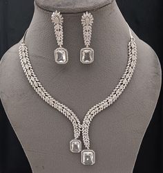 Faux CZ Diamonds White Necklace Earrings Set, Bridal Dangler Earrings, Bridal Choker, Party Wear Silver Necklace Earrings, Statement Piece ITEM DESCRIPTION Metal        = Silver Plated Occasion  = Wedding, Party Wear, Bridal Color        = White and Silver Size          = Necklace Length = 7 Inches Long, Earring Size = 2.5 Inches Long,  Free Shipping 100% Satisfaction Guarantee: 1 Year Warranty, Long Lasting Plating, High-Quality Stones Occasion: Perfect choice for any Indian occasion.  Care: It Bridal Choker, Dangler Earrings, White Necklace, Fancy Jewelry, Earrings Statement, Cz Diamond, Necklace Earring Set, Necklace Earrings, Earrings Set