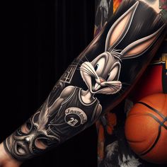 a rabbit tattoo on the arm next to a basketball