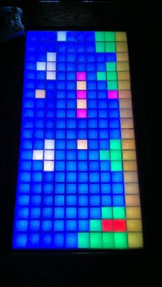 a colorful display with squares on it in the dark