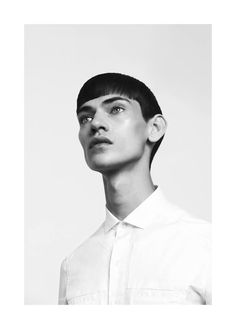 a black and white photo of a woman with short hair wearing a shirt and tie