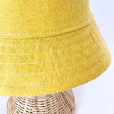 This yellow bucket hat is the perfect thing for babies toddlers and kids on sunny summer days! Washable linen and cotton fabirc makes it an easy go to for at the park, the beach, or even the backyard! This hat will protect delicate skin from the sun and will quickly become a favorite accessory! I made this sun hat from a bold yellow colored linen/cotton blend fabric. The strap closes with snaps under the chin keeps them from pulling it off. Brim measures approx. 2.25 inches. SIZES AVAILABLE 0-3 mos. - fits 14" to 16" head circumference 3-6 mos. - fits 15" to 17" head circumference 6-12 mos. - fits 16" to 18" head circumference 12-24 mos. - fits 17.5" to 19.5" head circumference Small (3 to 5 yrs) - fits 19" to 21" head circumference OVERVIEW + Sewn by me + Yellow Linen and Cotton blend Fab Summer Cotton Sun Hat For Everyday, Lightweight Cotton Summer Bucket Hat, Summer Lightweight Cotton Bucket Hat, Solid Color Cotton Sun Hat For Summer, Cotton Summer Sun Hat, Solid Cotton Summer Sun Hat, Solid Color Cotton Summer Sun Hat, Yellow Cotton Casual Sun Hat, Casual Yellow Cotton Sun Hat