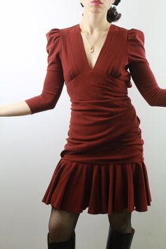 Carven 2000s burgundy wool draped dress with a breathless, beautiful back, puffed sleeves and deep neckline. A small thread pulled hidden between the pleats. Size 38 ita, 6 uk. Very good conditions. Shipping of this item takes one week for dry cleaning. I wish the dress is perfect for you! All items are vintage and used. However they are all in good to excellent condition. Any defect is specified. Sometimes, small signs of use are to be considered normal. No exchanges and returns, but ask me eve Fitted Dress With Draped Sleeves For Fall, Fall Mini Dress With Draped Sleeves For Date Night, Formal Fitted Puff Sleeve Dress With Pleated Details, Formal Fitted Pleated Puff Sleeve Dress, Fitted Puff Sleeve Pleated Dress For Party, Elegant Brown Puff Sleeve Dress, Cocktail Puff Sleeve V-neck Ruched Dress, Cocktail V-neck Puff Sleeve Ruched Dress, Elegant Burgundy Ruched Mini Dress