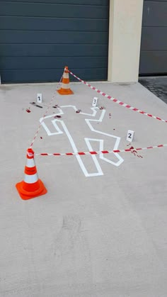 an orange traffic cone sitting on top of a cement floor