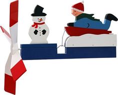 a person laying on a bed next to a snowman with a red and white striped tie