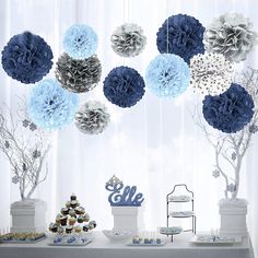 a dessert table with blue and silver decorations