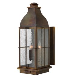 an old fashioned wall light with glass panels