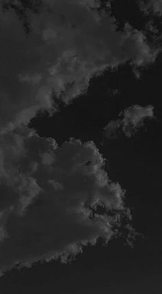 black and white photograph of clouds in the sky with an airplane flying by onlookers