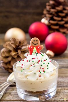 a small glass bowl filled with whipped cream and topped with a gingerbread man