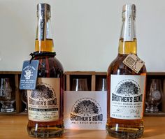 two bottles of brother's bond sit on a wooden table next to each other