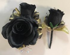 two black roses with gold sequins on them are sitting next to each other